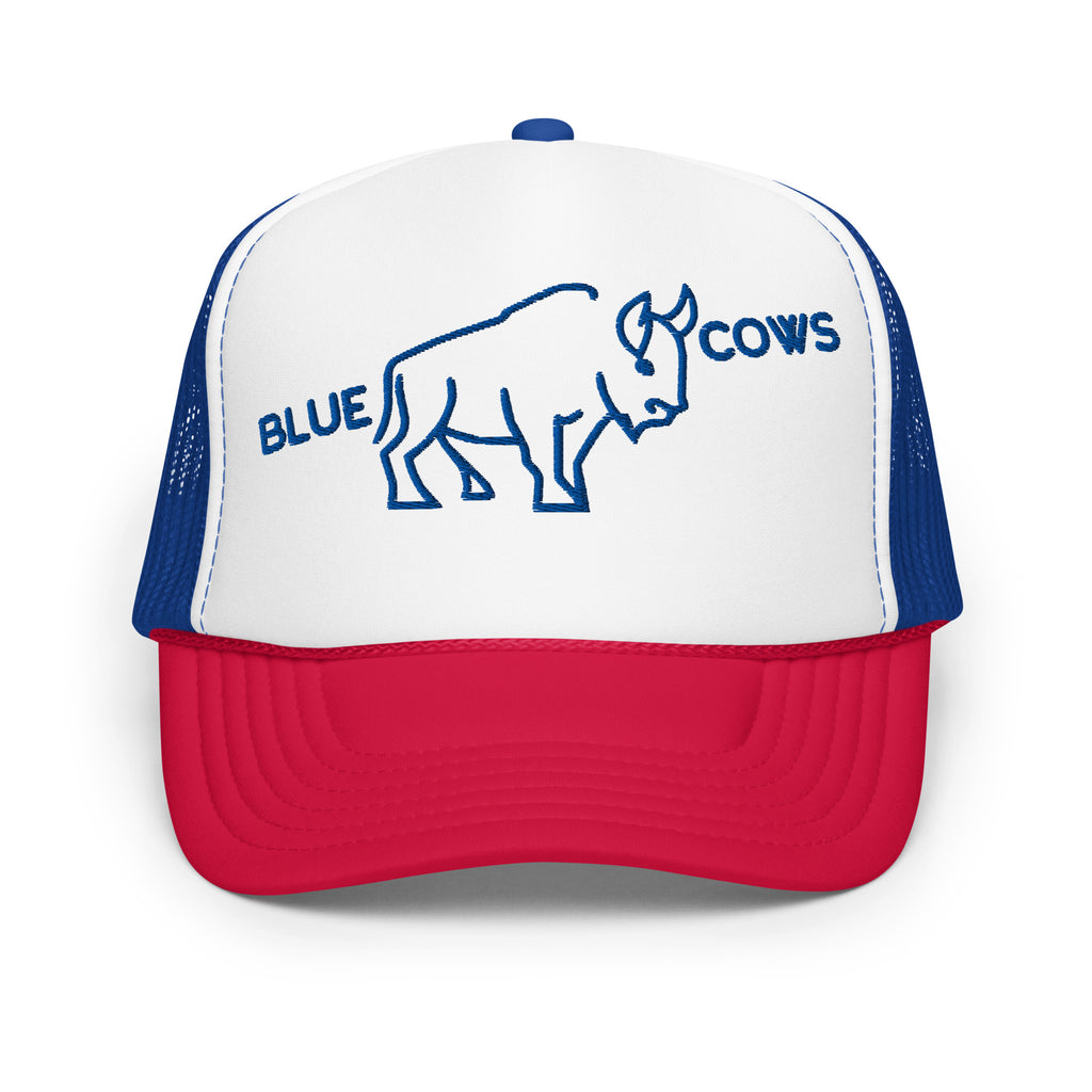 White, red, and blue foam trucker hat with a red brim, blue mesh back, and a white front panel featuring a minimalist blue buffalo illustration and the text 'BLUE COWS' embroidered in blue.